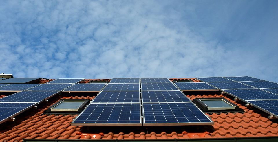 A picture of solar panels lying on an orange roof.