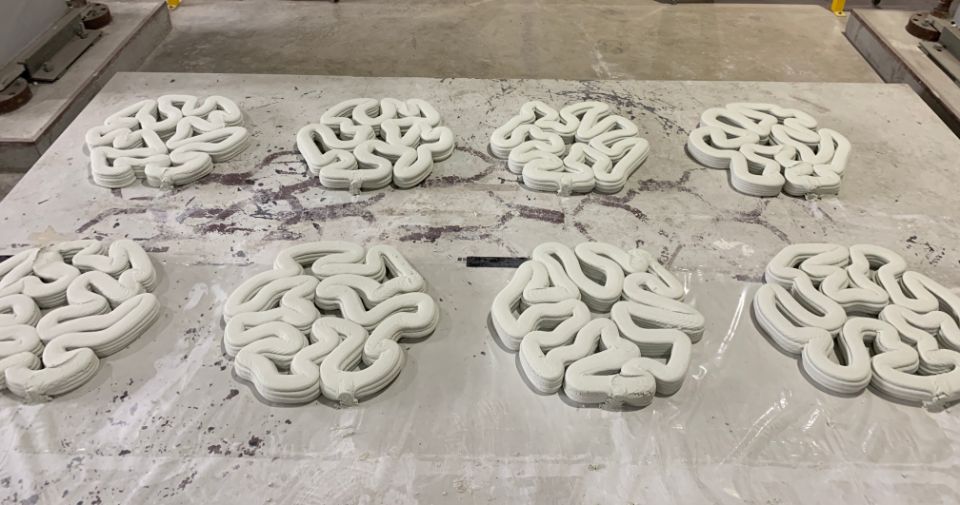 A photo of 8 coral fragments made with 3D concrete printing.