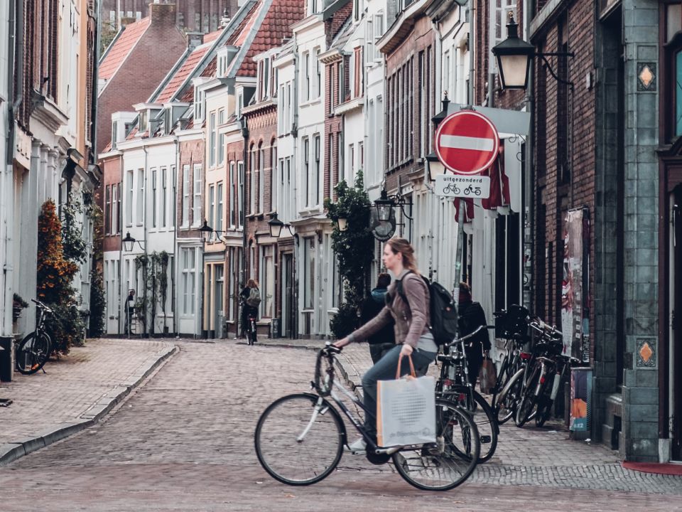 A woman on a bicycle in a city.