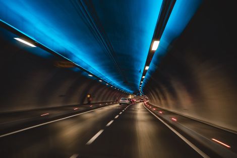 Some cars driving through a tunnel.