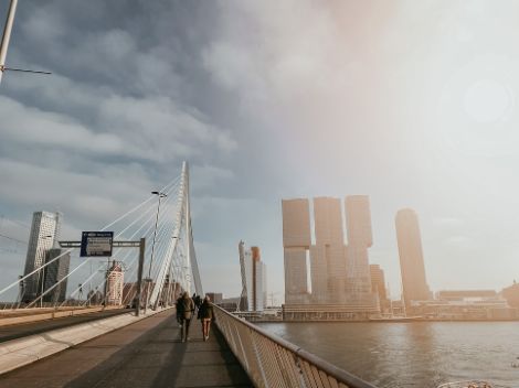 Photo from the Erasmus Bridge in Rotterdam. People are walking on it.
