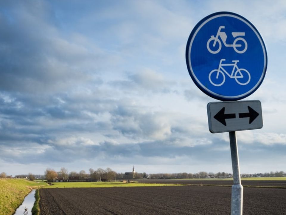 A blue bike path sign.
